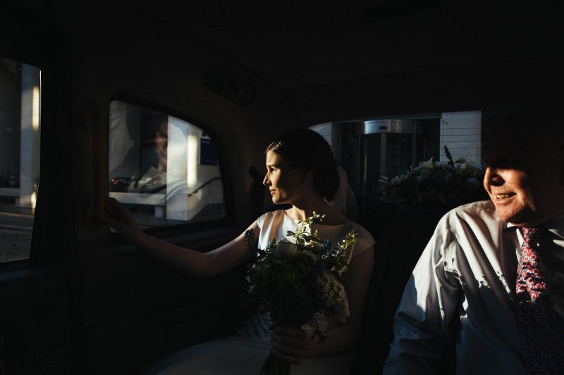bride looking out of the window by Lyndsey Goddard
