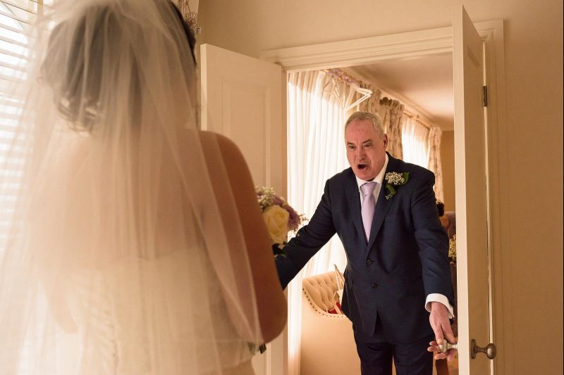 dad seeing daughter in wedding dress by Neil Redfern